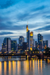 Fototapeta na wymiar Vertical image of illuminated Frankfurt skyline at night