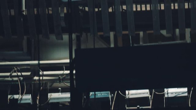 Theatre scene backstage metal constructions and electronics, dark room panning shot