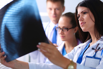 Young group of doctors looking at x-ray