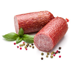Salami smoked sausage, basil leaves and peppercorns isolated on white background cutout