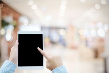 Hand touching tablet with on wood table background, mock up, template, top view