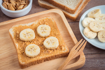 Bread with peanut butter and banana on plate
