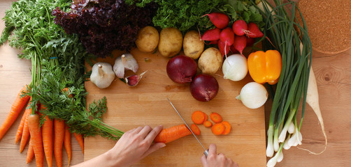 Young woman cutting vegetables in the kitchen