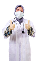 Young female doctor  wearing hijab in a medical mask and surgical gloves with a stethoscope on the neck working. Health Concept