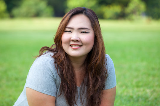 Happy fatty asian woman posing outdoor