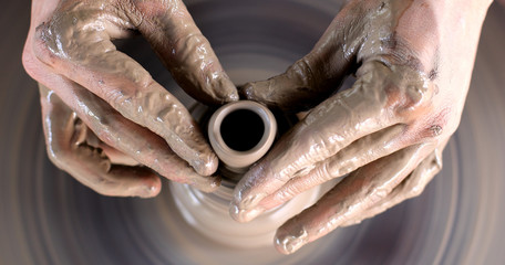 hands working on pottery wheel