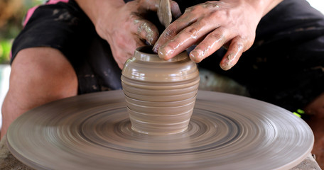 hands working on pottery wheel