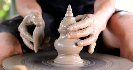 hands working on pottery wheel