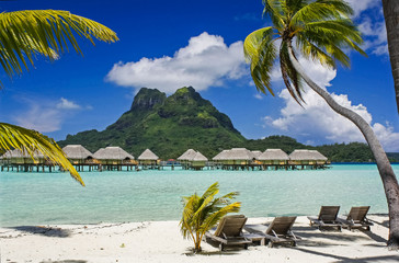 Bora Bora's Mount Otemanu looking down on above water hotel cabins