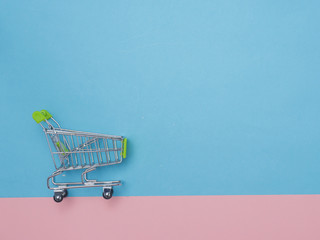 Collection of shopping cart  full of shopping time.Top view or flat lay composition cart on color...
