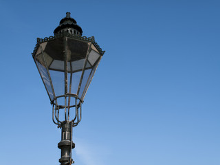 Fototapeta na wymiar Period styled cast iron streetlamp against a clear blue sky