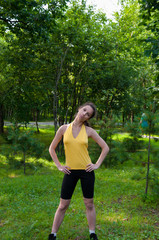 Girl engaged fitness in the park, exercise head tilts