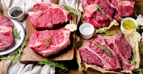 Raw beef meat on a dark wooden board.