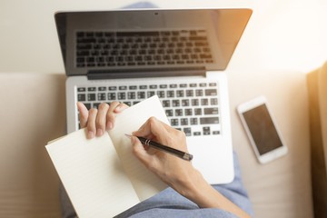 Women holding a pens writing a notebook. Recording concept