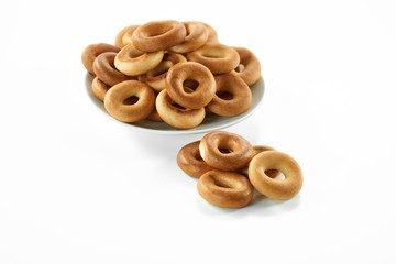 Bowl full of delicious crispy bagels isolated on white dessert bakery pastries baking concept.