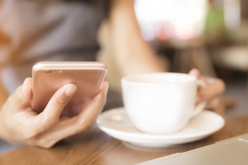Women are drinking coffee She uses the phone to communicate. Concept, working women, technology, business cafe