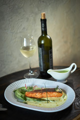 Baked trout with sauce and broccoli