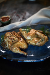 Grilled chicken Tabaka with sauce on stone plate. jpg