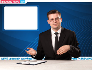 Television reporter telling breaking news at his studio desk with copy space