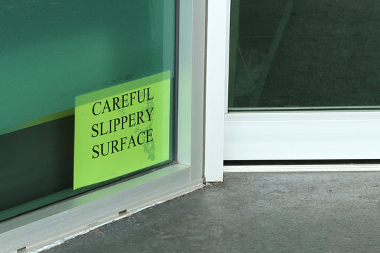 Careful Slippery Surface Sign Near The Entrance Of A Building