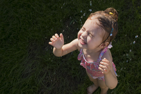 Happy Child Taking Shower Outdoors. Summer Vacation And Healthy Lifestyle Concept