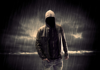 Anonymous terrorist in hoodie at night