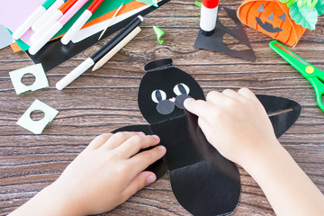 Create a gift box black cat Halloween. The child glues the details of the application of the box. Children's art project, craft for children. Craft for kids.