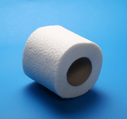 Toilet paper roll isolated on blue background