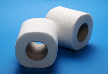 Toilet paper rolls isolated on blue background