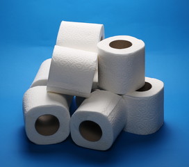 Toilet paper rolls isolated on blue background
