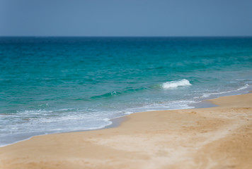 Fototapeta na wymiar A tranquil tropical beach on a sunny day. Selective focus.