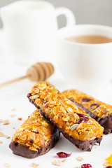 granola bars with dried fruits and honey in chocolate