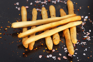 Pile of italian grissini on dark background. Close up.