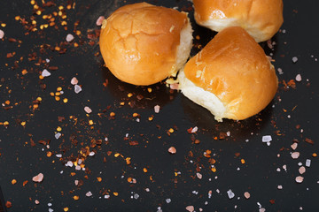 Fresh lush buns with garlic on a dark background.