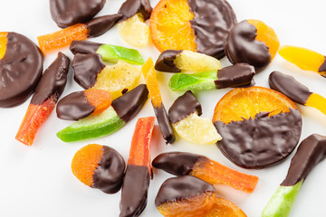 Candied fruit in chocolate on white