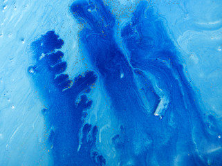 Marbled blue and golden abstract background. Liquid marble pattern