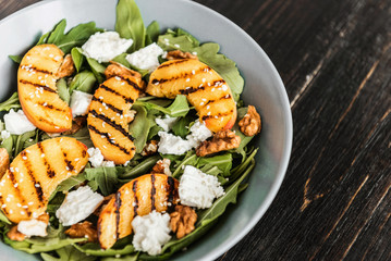 Salad of peaches grilled, ricotta and arugula. Healthy food