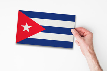 Male hand holding cuba flag