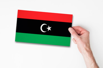 Male hand holding libya flag