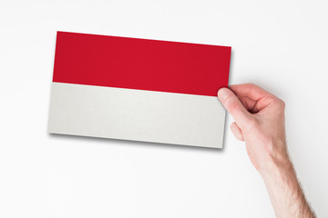 Male hand holding indonesia flag