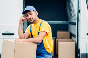 Workman or courier holds carton box in hands