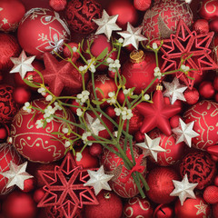 Christmas mistletoe with red and gold bauble forming a festive background.