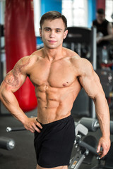 Fototapeta na wymiar Bodybuilder posing in the gym