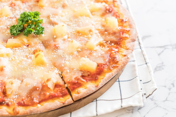 hawaiian pizza on table