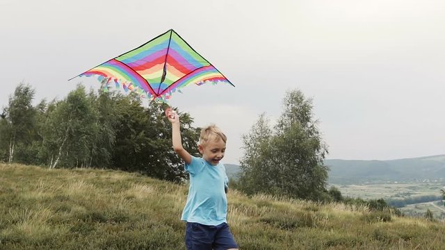 The boy runs and launches a snake in the mountains