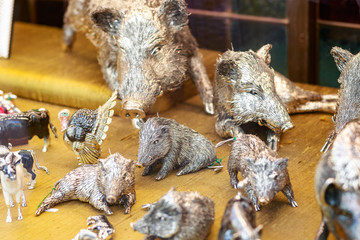 Handcrafted silver metal wild boar statuettes in the window of a jewellery shop on the Ponte Vecchio (Old Bridge)