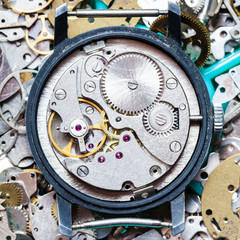 clockwork on heap of clock spare parts