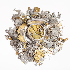 top view of pocket watch on heap of spare parts