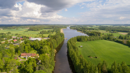 Fototapeta na wymiar Aerial view of a green field from and river