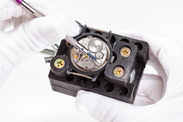 repairing of wristwatch with screwdriver close up